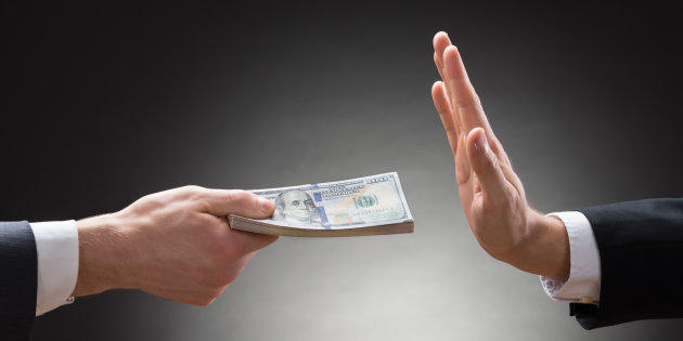 Close-up Of Businessman Hand Rejecting The Money Offered By Other Businessman